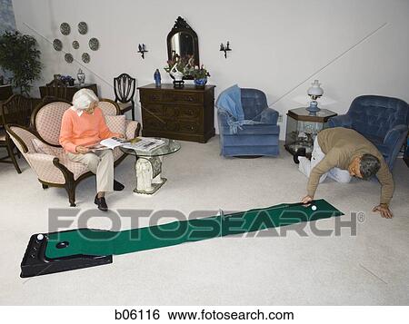 Mature man using a putting set View Large Photo Image Stock Photograph - Mature man using a putting set. Fotosearch
