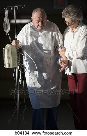 Mature man walking with IV with mature woman View Large Photo Image Picture - Mature man walking with IV with mature woman. Fotosearch