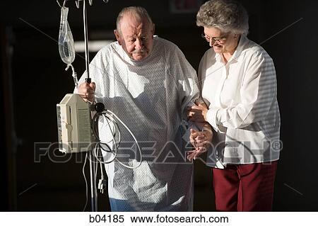 Mature man walking with IV with mature woman View Large Photo Image Stock Photography - Mature man walking with IV with mature woman. Fotosearch