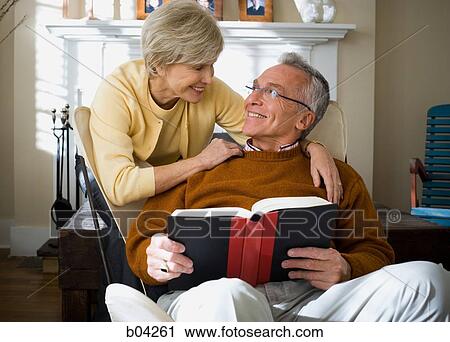 Mature man with book and mature woman View Large Photo Image Stock Image - Mature man with book and mature woman. Fotosearch