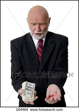 Mature man with handful's of medicine and money View Large Photo Image Picture - Mature man with handful's of medicine and money. Fotosearch