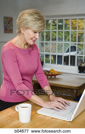 Mature woman with laptop View Large Photo Image Stock Photo - Mature woman with laptop. Fotosearch