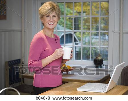 Stock Photo - Mature woman with laptop. Fotosearch
