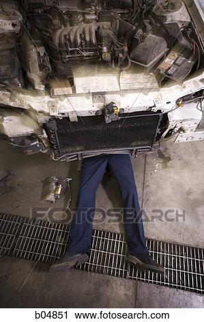Mechanic under car waist down View Large Photo Image Stock Image - Mechanic under car waist down. Fotosearch