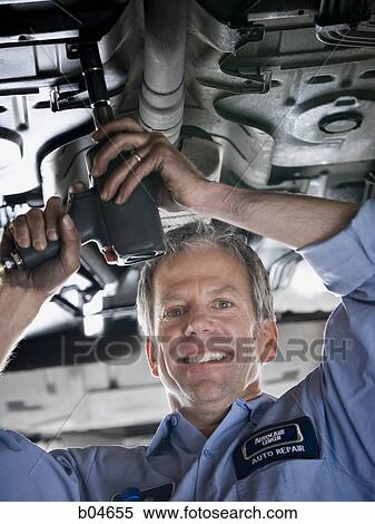 Mechanic working on car View Large Photo Image Stock Photography - Mechanic working on car. Fotosearch