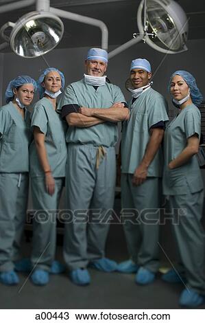 Stock Image - Medical personnel in operating room. Fotosearch