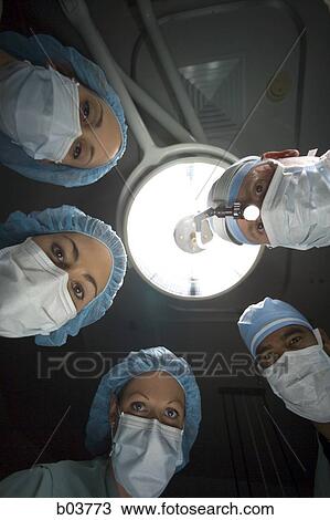 Stock Image - Medical personnel in surgery. Fotosearch