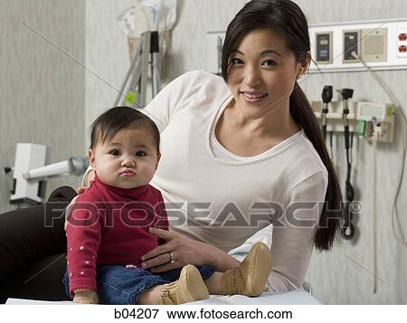 Mother and baby in examining room View Large Photo Image Stock Photo - Mother and baby in examining room. Fotosearch