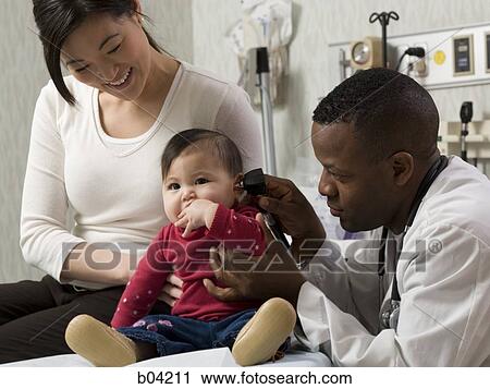 Mother and baby in examining room with doctor View Large Photo Image Stock Image - Mother and baby in examining room with doctor. Fotosearch