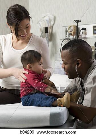 Mother and baby in examining room with doctor View Large Photo Image Stock Photo - Mother and baby in examining room with doctor. Fotosearch