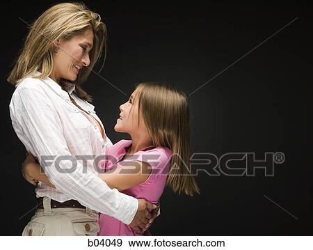 Stock Photo - Mother and daughter hugging. Fotosearch