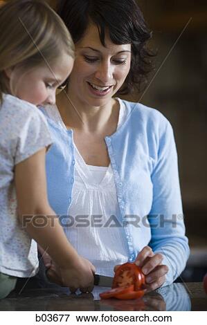 Mother and daughter slicing tomato View Large Photo Image Stock Photo - Mother and daughter slicing tomato. Fotosearch