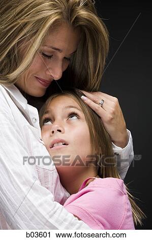 Mother embracing daughter View Large Photo Image Stock Image - Mother embracing daughter. Fotosearch