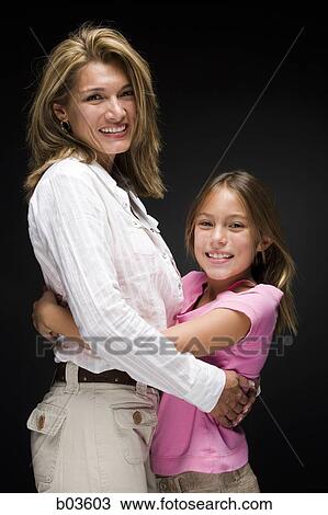 Mother embracing daughter View Large Photo Image Stock Image - Mother embracing daughter. Fotosearch