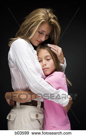 Mother embracing daughter View Large Photo Image Stock Photo - Mother embracing daughter. Fotosearch