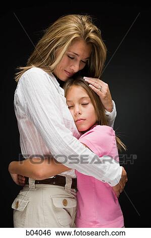 Mother embracing daughter View Large Photo Image Stock Photograph - Mother embracing daughter. Fotosearch