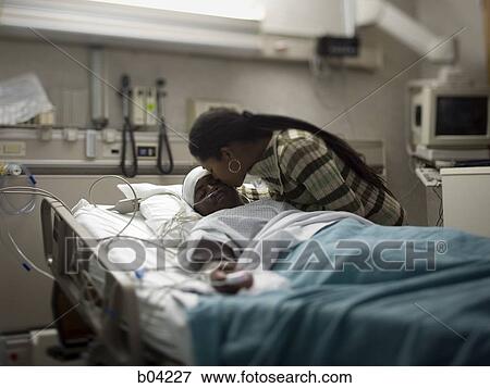 Mother kissing boy in hospital bed with head bandages View Large Photo Image Stock Photo - Mother kissing boy in hospital bed with head bandages. Fotosearch
