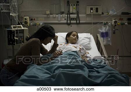 Mother sitting nervously by daughter in hospital bed View Large Photo Image Stock Image - Mother sitting nervously by daughter in hospital bed. Fotosearch