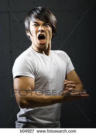 Muscular man with clenched fist shouting View Large Photo Image Stock Photo - Muscular man with clenched fist shouting. Fotosearch