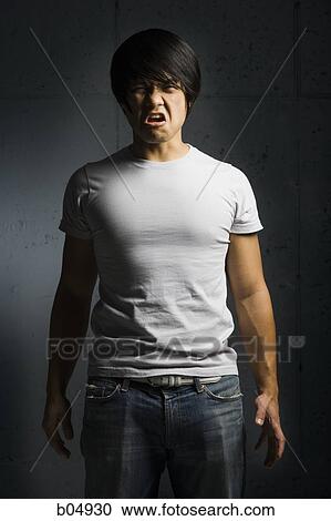 Muscular man with tensed arm looking hostile View Large Photo Image Stock Image - Muscular man with tensed arm looking hostile. Fotosearch