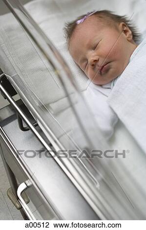 Stock Image - Newborn girl in incubator. Fotosearch