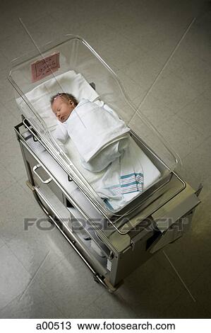Stock Image - Newborn girl in nursery from above. Fotosearch