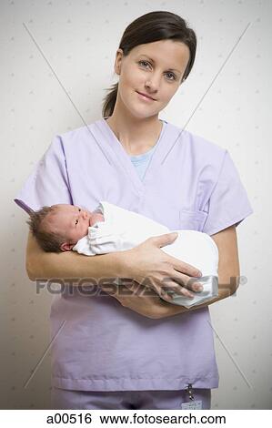 Nurse holding newborn baby View Large Photo Image Stock Photograph - Nurse holding newborn baby. Fotosearch