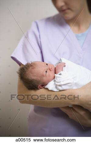 Stock Photography - Nurse holding newborn baby. Fotosearch
