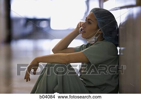 Nurse in scrubs on cell phone View Large Photo Image Picture - Nurse in scrubs on cell phone. Fotosearch