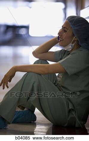Nurse in scrubs on cell phone View Large Photo Image Stock Photography - Nurse in scrubs on cell phone. Fotosearch