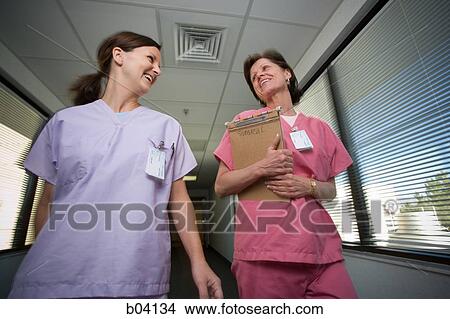 Picture - Nurses walking and talking. Fotosearch