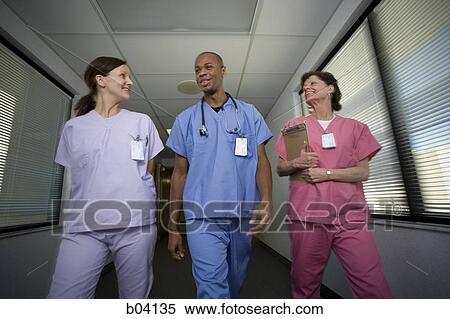 Nurses walking and talking View Large Photo Image Stock Photography - Nurses walking and talking. Fotosearch