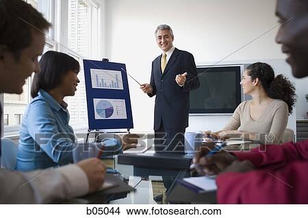Picture - Older Businessman making presentation at meeting. Fotosearch