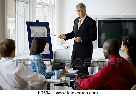 Older Businessman making presentation at meeting View Large Photo Image Stock Image - Older Businessman making presentation at meeting. Fotosearch