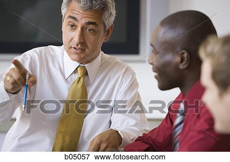 Stock Photo - Older businessman talking at business meeting. Fotosearch