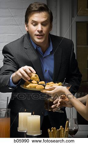 Partygoer eating View Large Photo Image Stock Image - Partygoer eating. Fotosearch