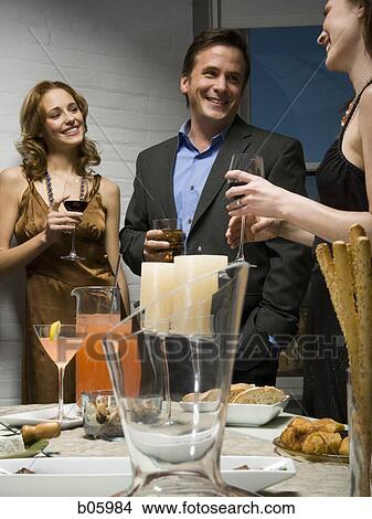 Partygoers socializing View Large Photo Image Picture - Partygoers socializing. Fotosearch