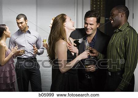 Stock Photo - Partygoers socializing. Fotosearch