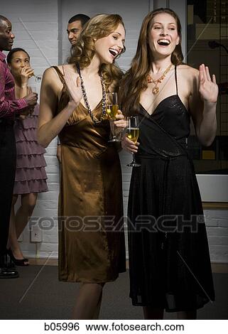 Stock Photograph - Partygoers socializing. Fotosearch