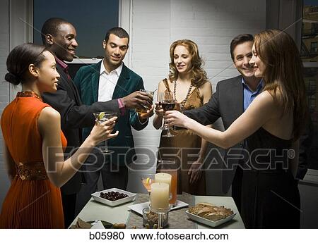 Stock Image - Partygoers toasting. Fotosearch