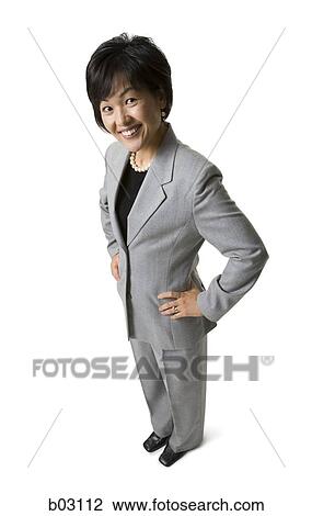 Stock Image - Portait of woman with hands on hip. Fotosearch