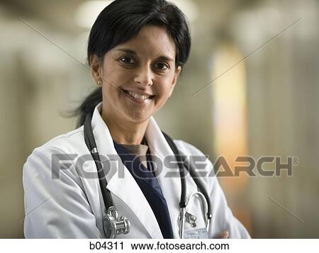 Portrait of a female doctor smiling View Large Photo Image Stock Image - Portrait of a female doctor smiling. Fotosearch