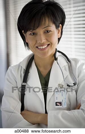 Portrait of a female doctor smiling View Large Photo Image Stock Photo - Portrait of a female doctor smiling. Fotosearch