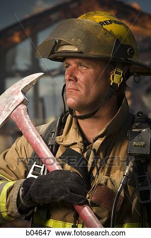 Portrait of a firefighter with axe View Large Photo Image Stock Photo - Portrait of a firefighter with axe. Fotosearch