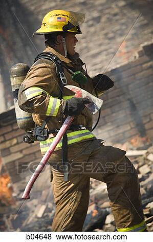 Stock Photo - Portrait of a firefighter with axe. Fotosearch