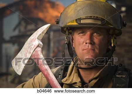Stock Photograph - Portrait of a firefighter with axe. Fotosearch