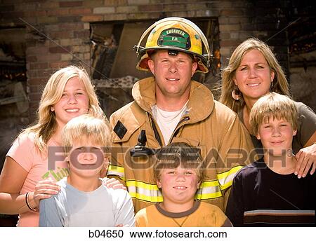 Stock Image - Portrait of a firefighter with family. Fotosearch