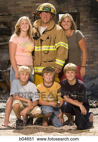Stock Image - Portrait of a firefighter with family. Fotosearch