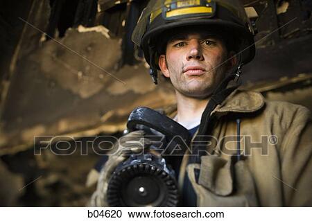 Portrait of a firefighter with fire hose View Large Photo Image Stock Image - Portrait of a firefighter with fire hose. Fotosearch