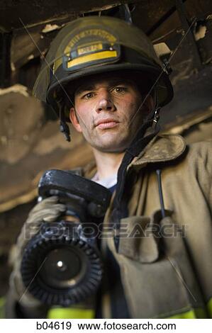 Portrait of a firefighter with fire hose View Large Photo Image Stock Photo - Portrait of a firefighter with fire hose. Fotosearch